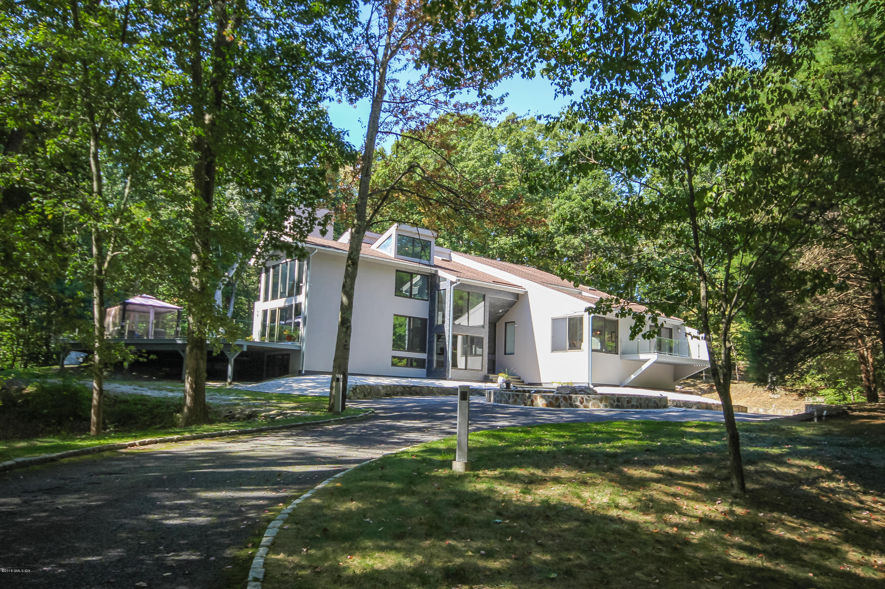 106 Porchuck Road Greenwich, CT 06831 - Photo 32 of 37 a front view of house with yard and green space