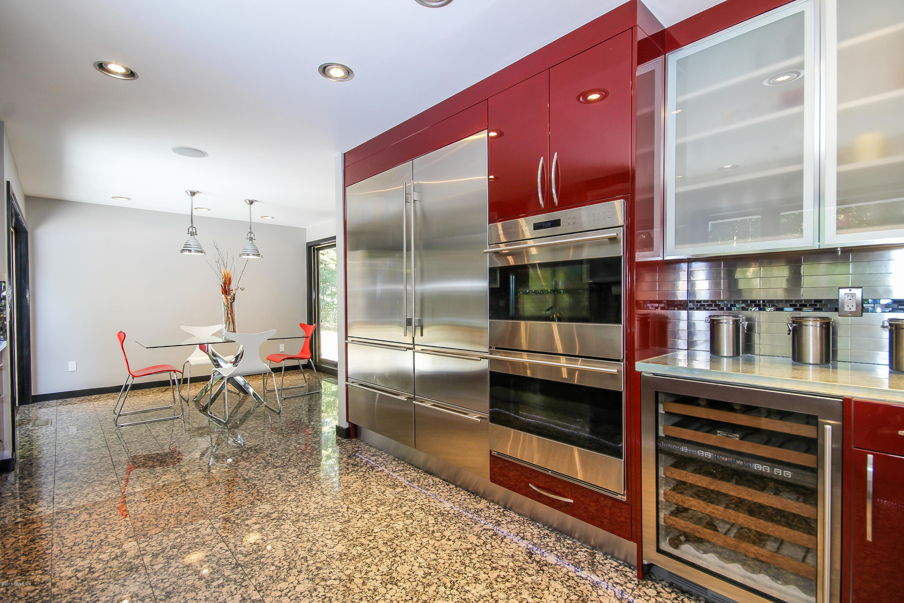 106 Porchuck Road Greenwich, CT 06831 - Photo 8 of 37 a kitchen with stainless steel appliances kitchen island granite countertop a refrigerator and a stove