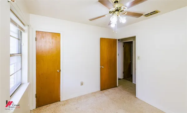 a view of a livingroom with a chandelier fan