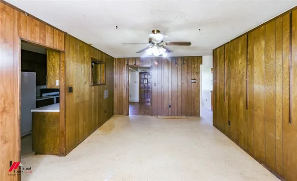 a view of a hallway with a chandelier fan