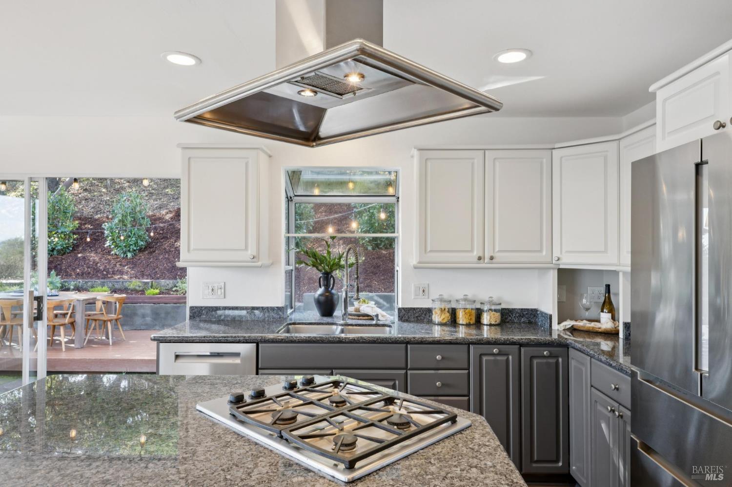 81 Rose Street San Rafael, CA 94901 - Photo 24 of 67 a kitchen with stainless steel appliances granite countertop a stove a sink dishwasher and cabinets with wooden floor
