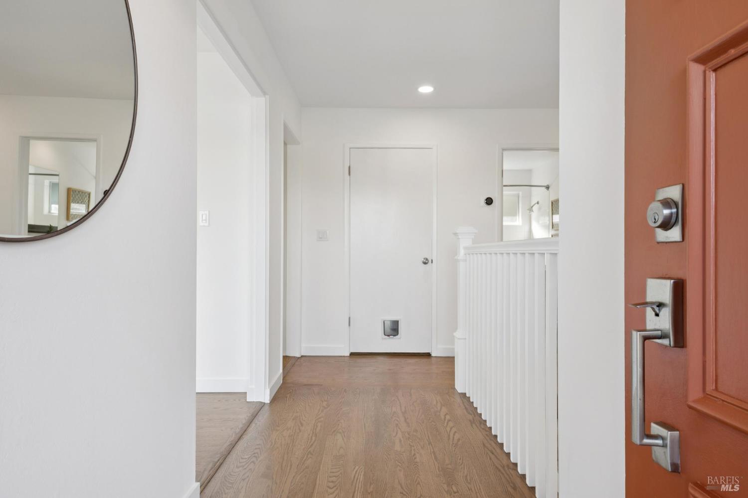 81 Rose Street San Rafael, CA 94901 - Photo 6 of 67 a view of a hallway with wooden floor and a bathroom
