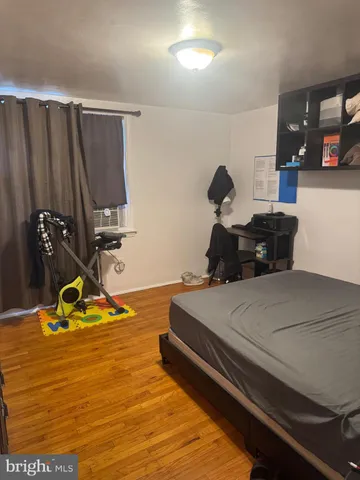 a bedroom with a bed table and window