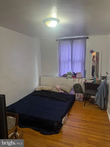 a bed sitting in a room next to a window