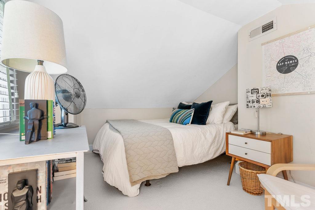 116 Hillcrest Road Raleigh, NC 27605 - Photo 14 of 30 a bed room with a bed mirror and a table