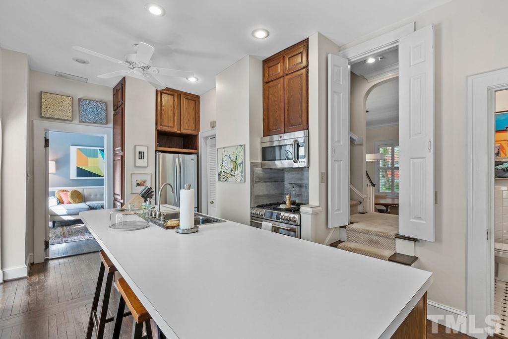 116 Hillcrest Road Raleigh, NC 27605 - Photo 8 of 30 a kitchen with a table chairs refrigerator and cabinets