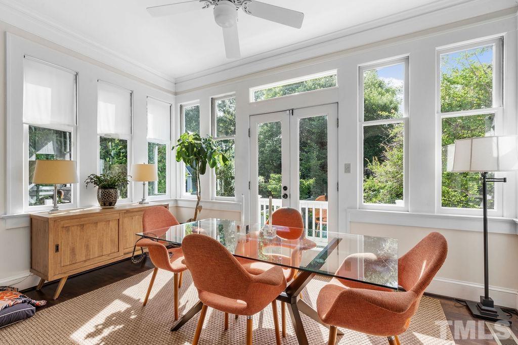 116 Hillcrest Road Raleigh, NC 27605 - Photo 9 of 30 a dining room with furniture a chandelier and glass door
