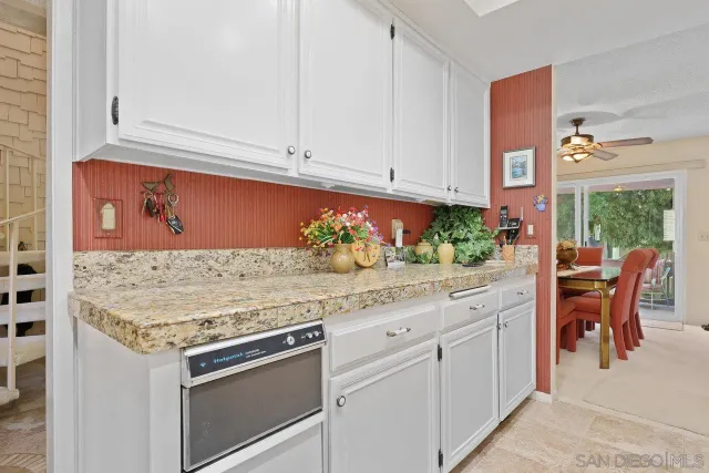 a kitchen with stainless steel appliances granite countertop a sink and a stove
