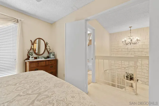 a bathroom with a double vanity sink mirror and chandelier