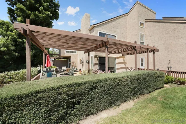 a view of a patio with table and chairs and potted plants