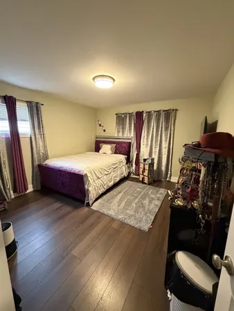 a bedroom with double bed and a window