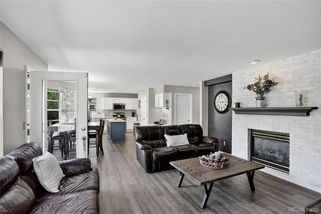 a kitchen with a sink a stove a refrigerator a center island and cabinets