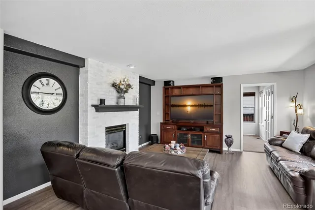 a living room with furniture a clock and a window