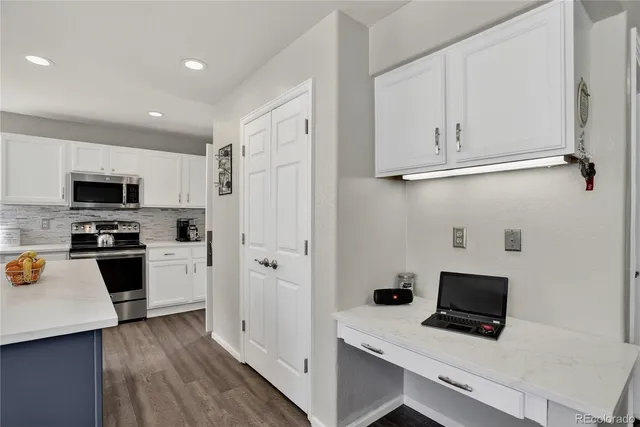 a bedroom with a bed a dresser and flat screen tv