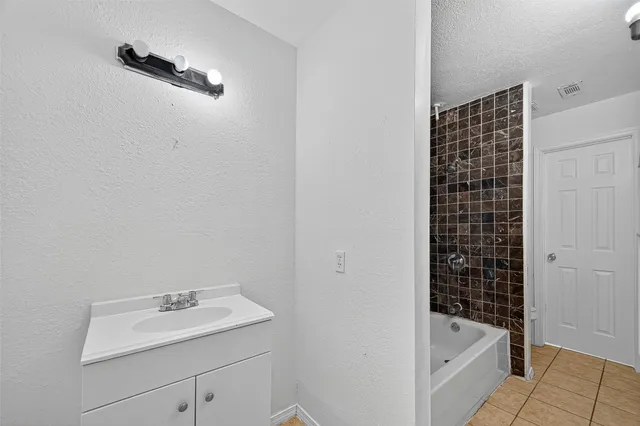 a bathroom with a bathtub and shower