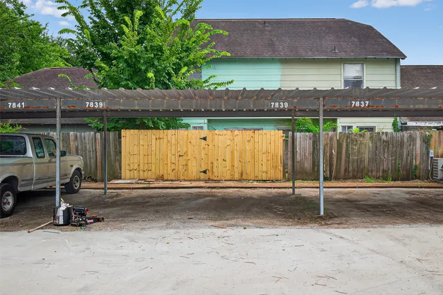 a backyard of a house with barbeque oven