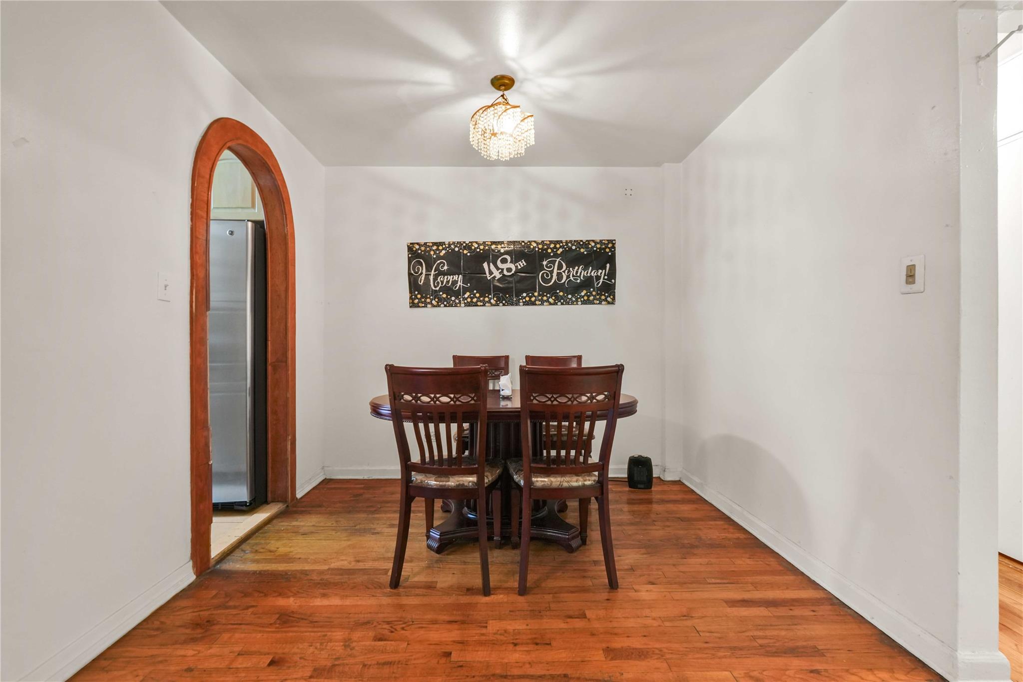 42-25 80th Street, Unit 1F Queens, NY 11373 - Photo 11 of 27 Dining room with baseboards, arched walkways, and wood finished floors