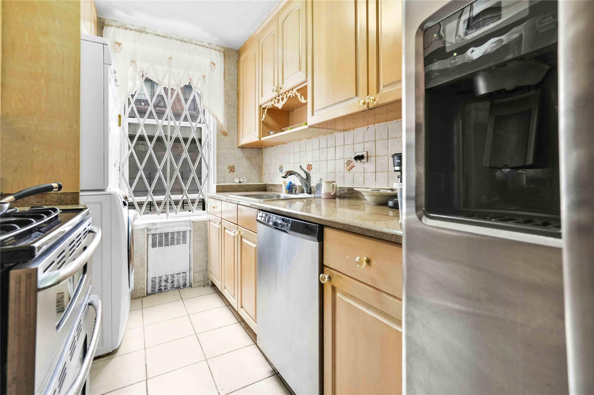 42-25 80th Street, Unit 1F Queens, NY 11373 - Photo 14 of 27 Kitchen with dishwasher, refrigerator, radiator heating unit, electric stove, and a sink