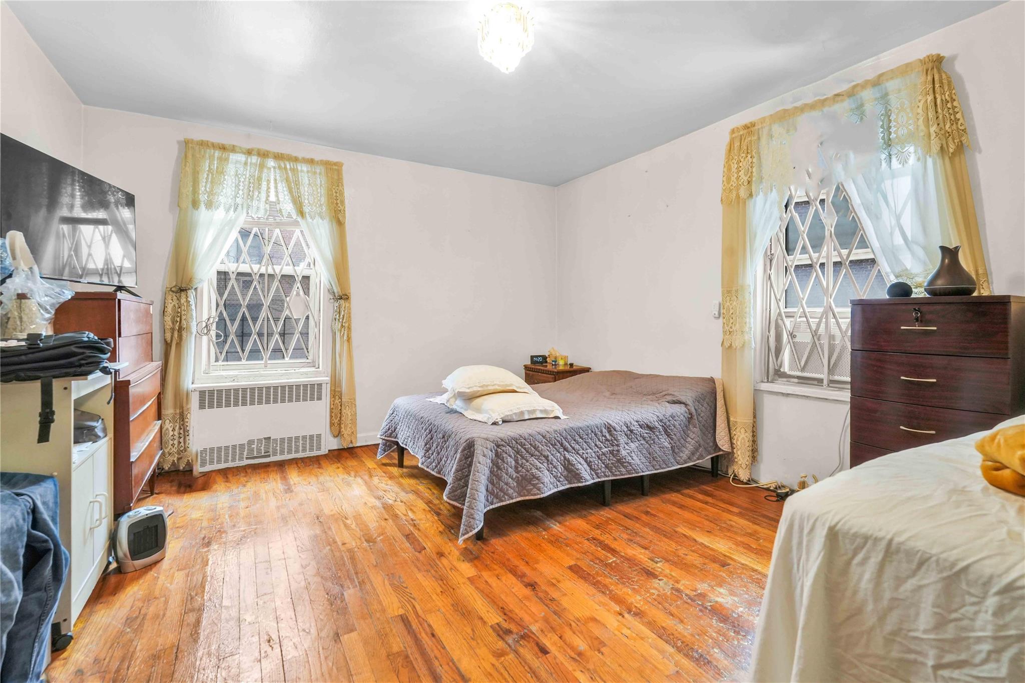 42-25 80th Street, Unit 1F Queens, NY 11373 - Photo 20 of 27 Bedroom featuring radiator heating unit and wood-type flooring