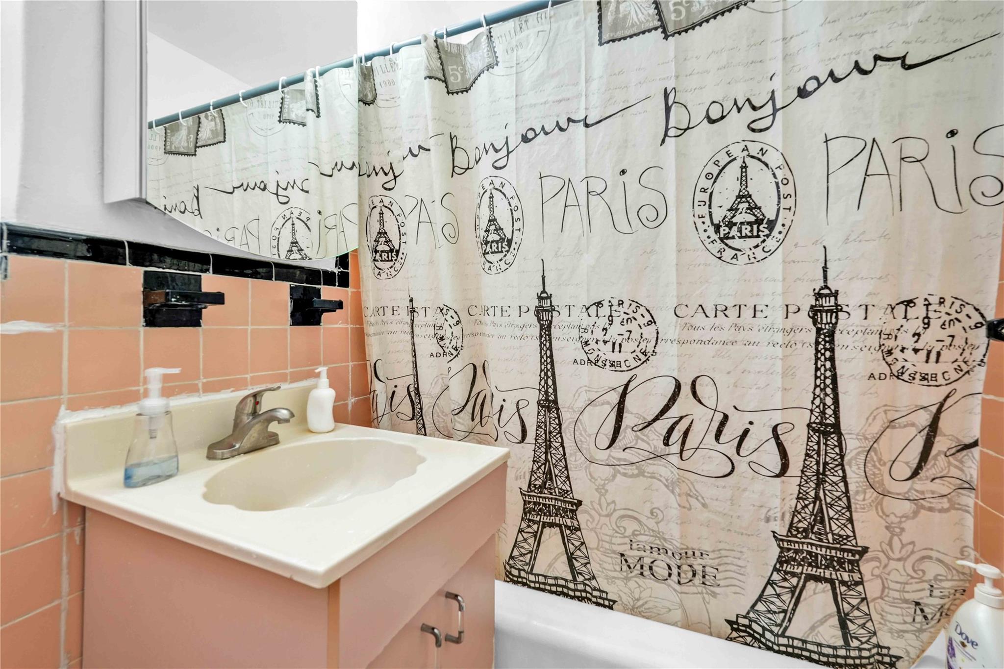 42-25 80th Street, Unit 1F Queens, NY 11373 - Photo 23 of 27 Bathroom featuring a shower with curtain, tile walls, and vanity