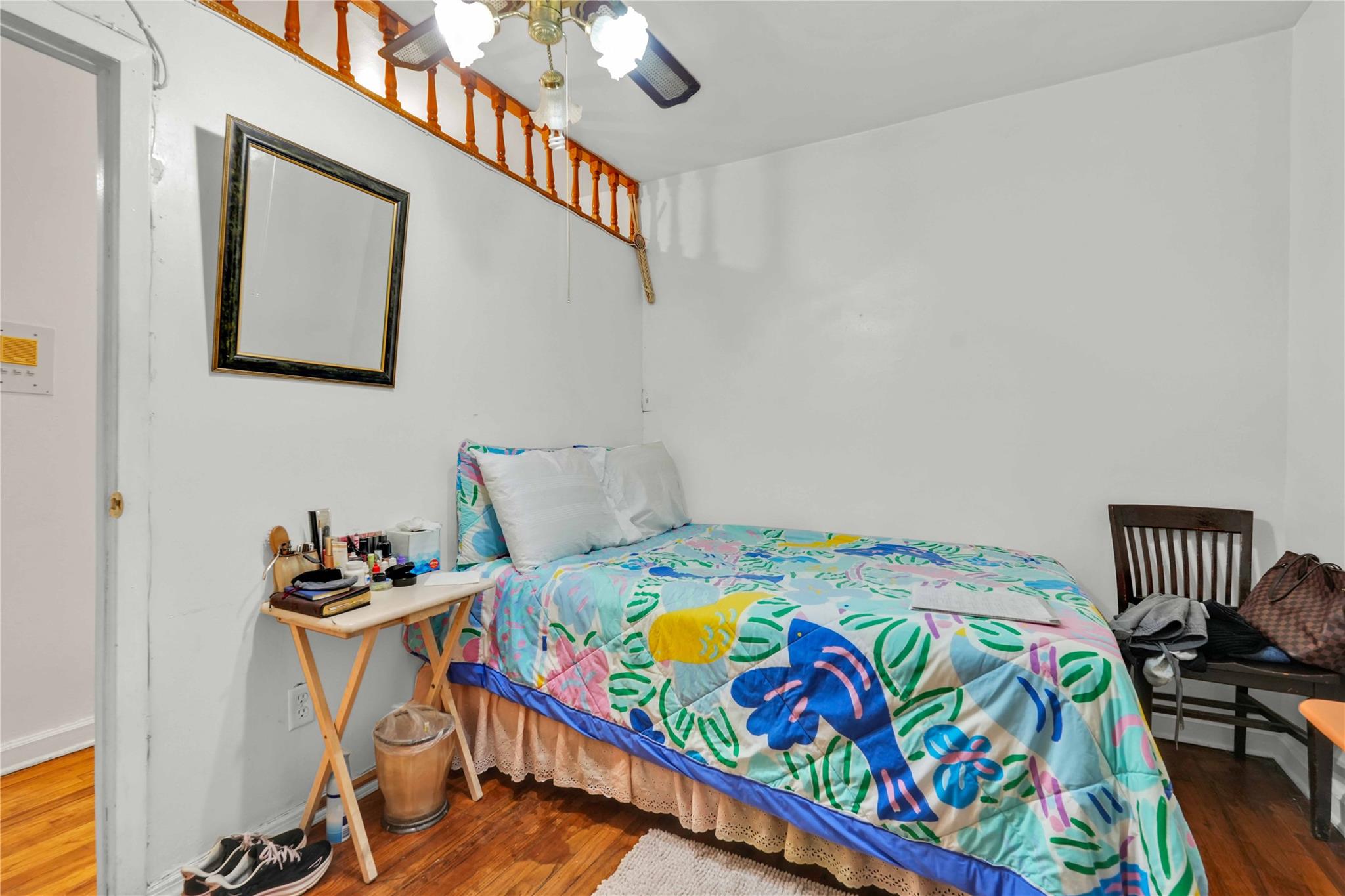 42-25 80th Street, Unit 1F Queens, NY 11373 - Photo 25 of 27 Bedroom with a ceiling fan, baseboards, and wood finished floors