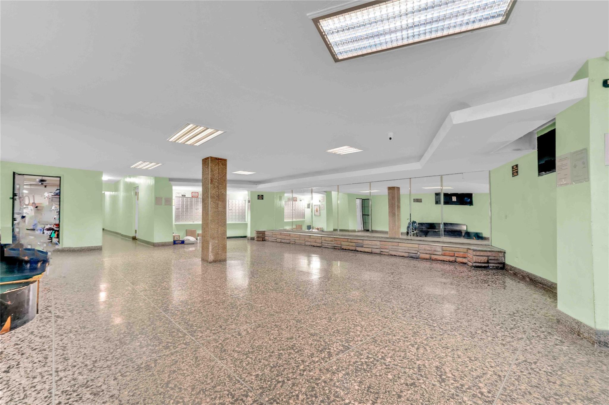 42-25 80th Street, Unit 1F Queens, NY 11373 - Photo 4 of 27 Miscellaneous room with baseboards and speckled floor