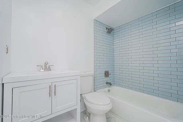 a bathroom with a sink a toilet and bathtub