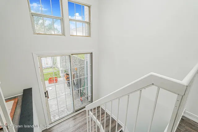 a view of an entryway with wooden floor