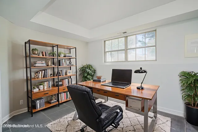 a view of a workspace with a bookshelf