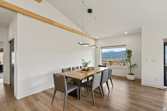 4499 North Seven Bridges Road, Unit 9 Eden, UT 84310 - Photo 13 of 65 Vaulted ceiling with exposed wood beam, wood-finish flooring, and a modern linear chandelier