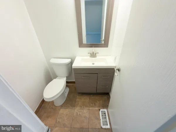 a bathroom with a sink toilet and mirror