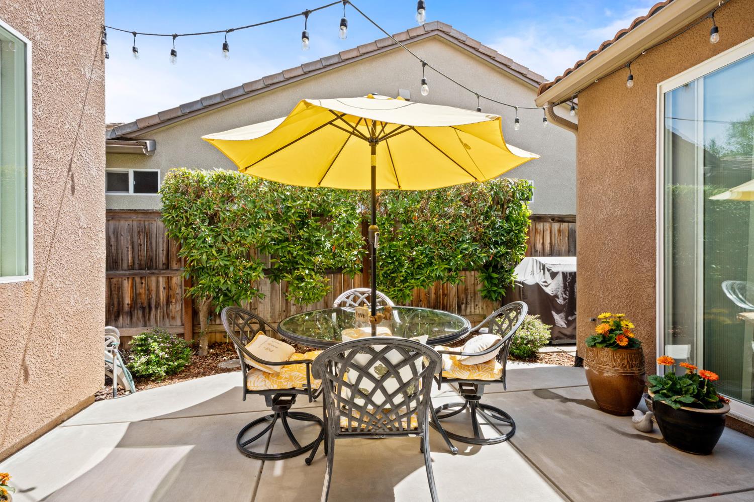 3942 Harlan Ranch Boulevard Clovis, CA 93619 - Photo 14 of 21 a view of a patio with a table and chairs under an umbrella
