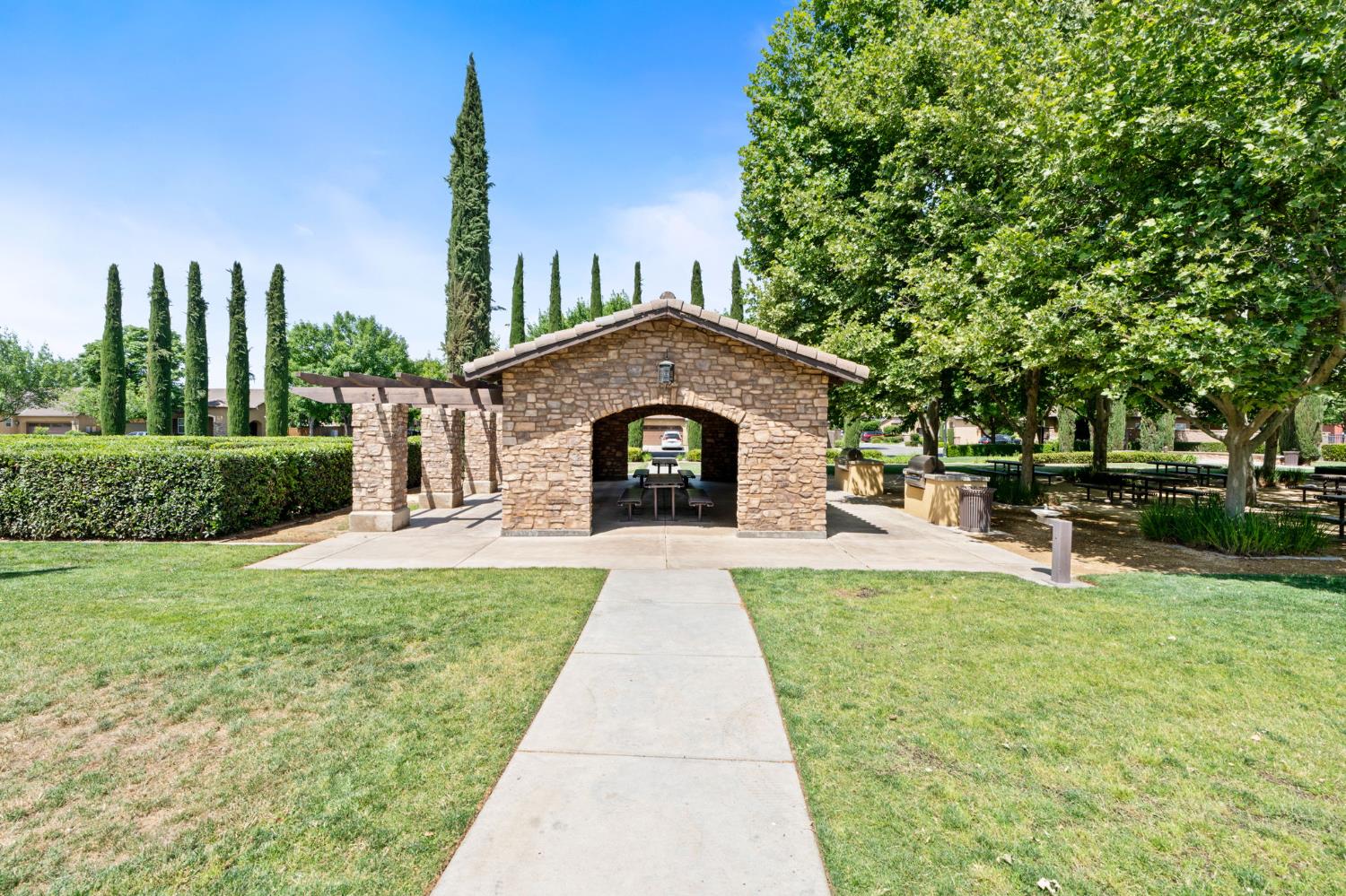 3942 Harlan Ranch Boulevard Clovis, CA 93619 - Photo 19 of 21 a front view of a house with garden