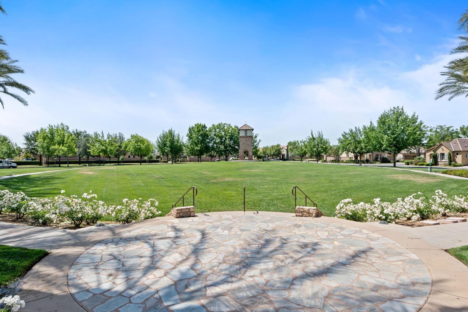 3942 Harlan Ranch Boulevard Clovis, CA 93619 - Photo 21 of 21 a view of a lake with a yard and large trees