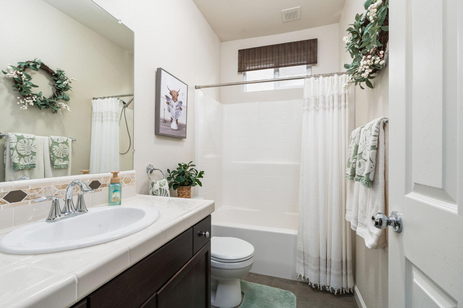 3942 Harlan Ranch Boulevard Clovis, CA 93619 - Photo 9 of 21 a bathroom with a sink toilet and shower