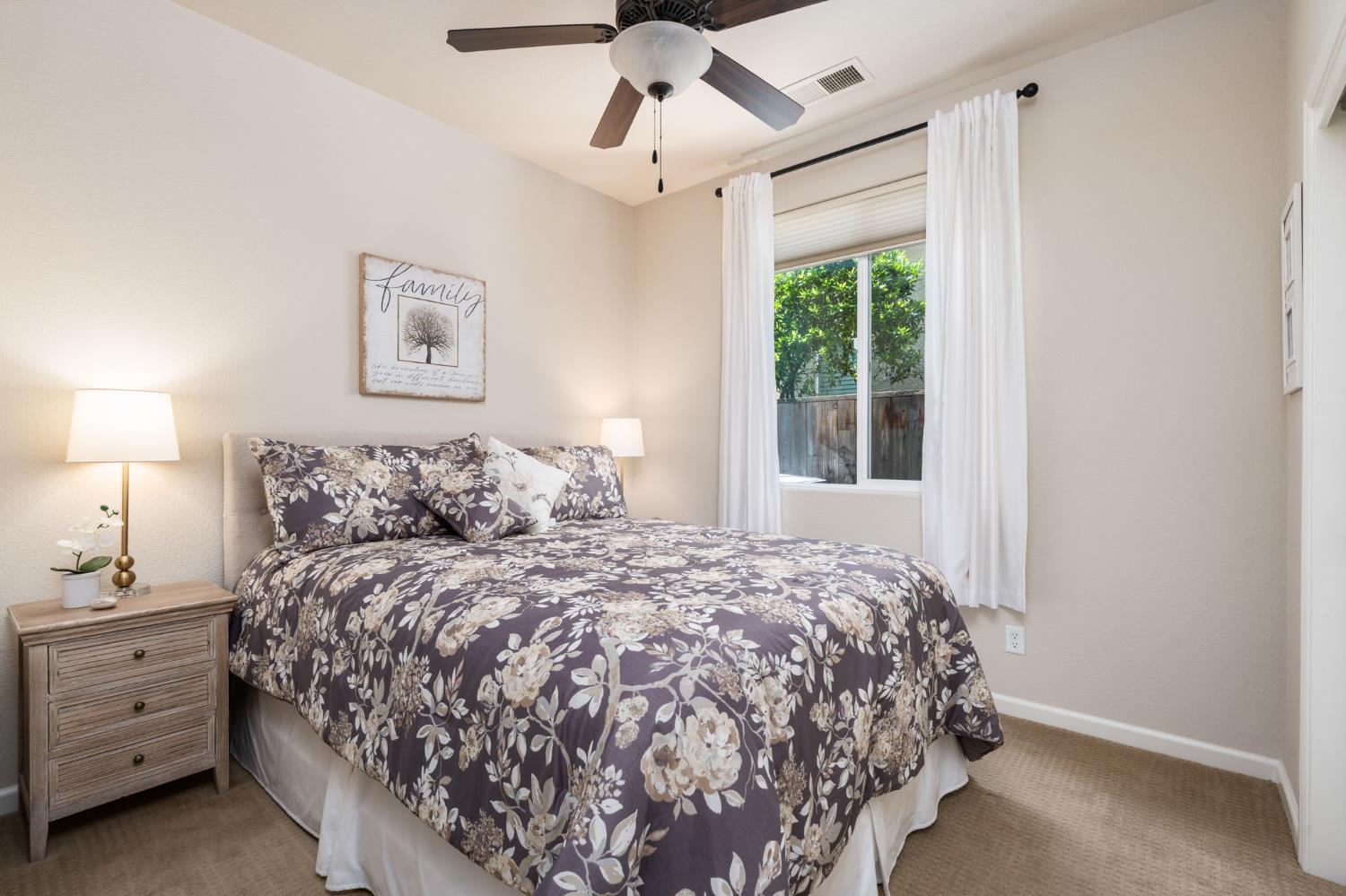 3942 Harlan Ranch Boulevard Clovis, CA 93619 - Photo 10 of 21 a bed sitting in a bedroom next to a window