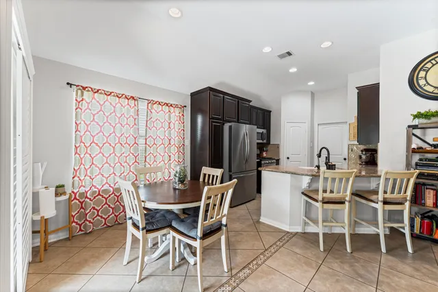 a view of a dining room with furniture and a window