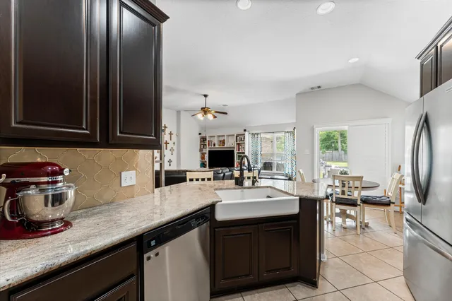 a kitchen with a sink appliances and cabinets