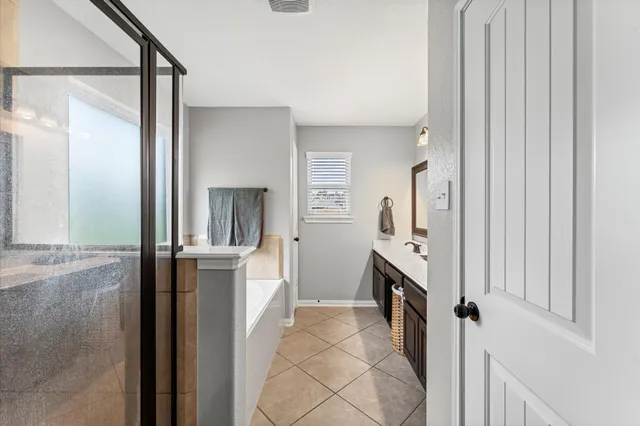 a spacious bathroom with a double vanity sink and a mirror