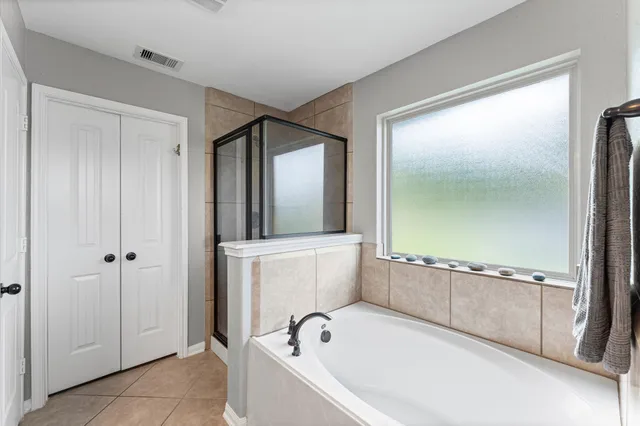 a bathroom with a bathtub and a shower
