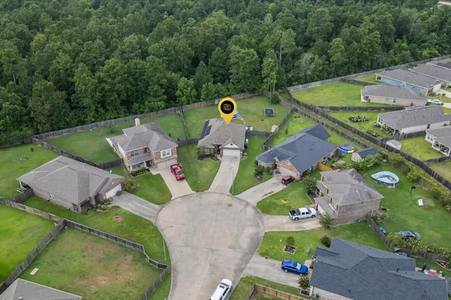 an aerial view of a house with outdoor space