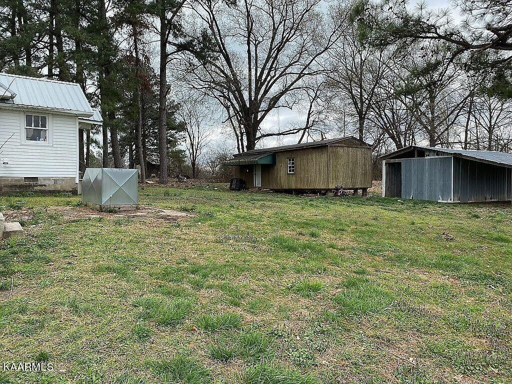 4135 Sidonia Road Sharon, TN 38255 - Photo 12 of 13 a view of a backyard with large trees