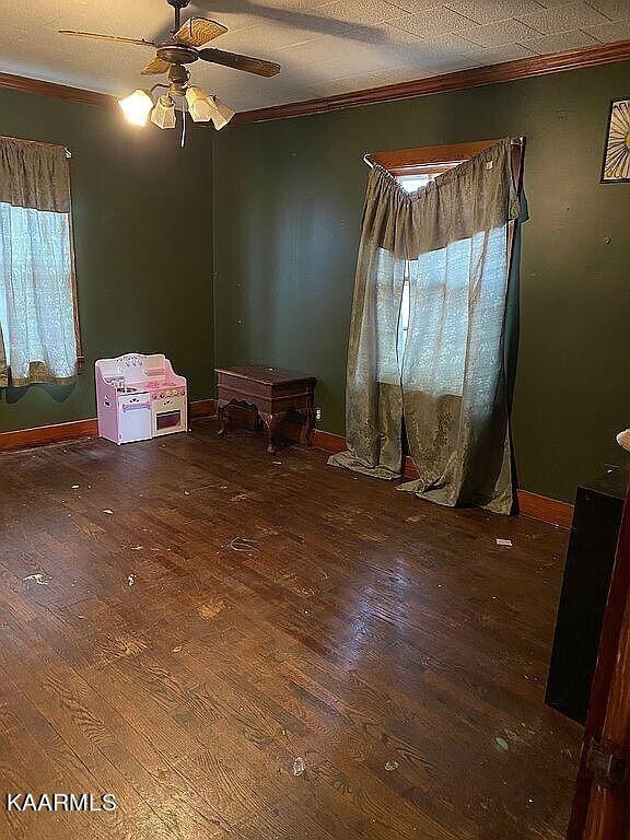 4135 Sidonia Road Sharon, TN 38255 - Photo 6 of 13 a bedroom with a bed and a chandelier