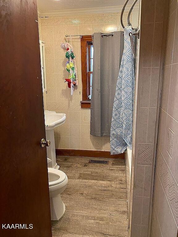 4135 Sidonia Road Sharon, TN 38255 - Photo 9 of 13 a bathroom with a toilet and shower