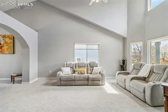 a bedroom with furniture and a large window