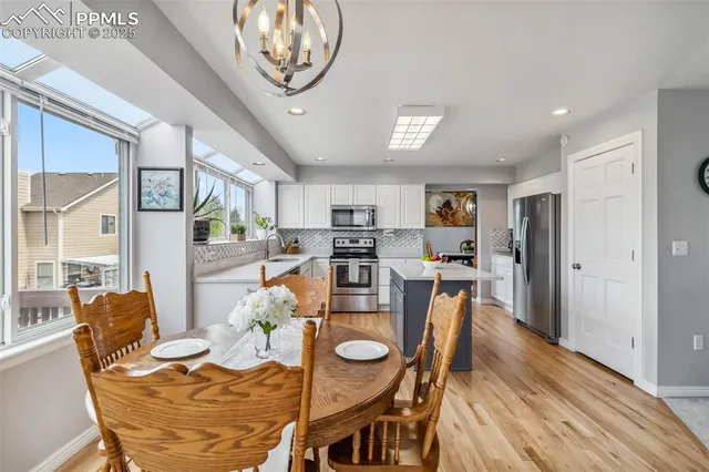 a view of a dining room with furniture window and wooden floor