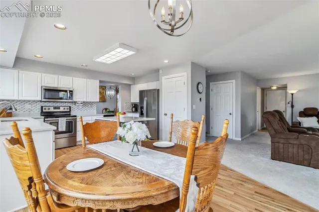 a living room with furniture a dining table and kitchen view