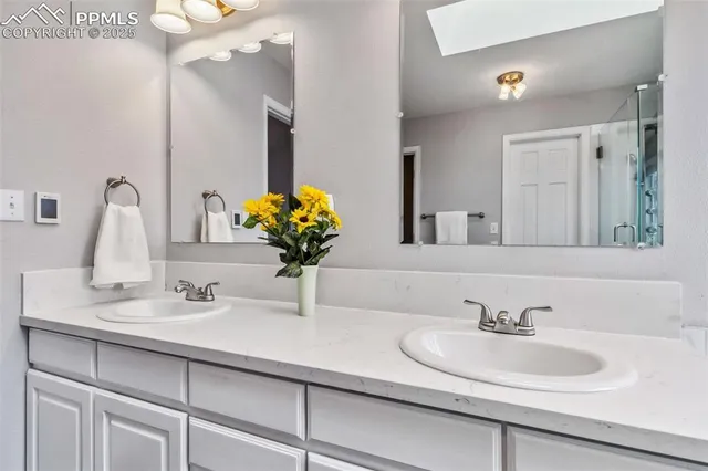 a bathroom with double sink and a mirror