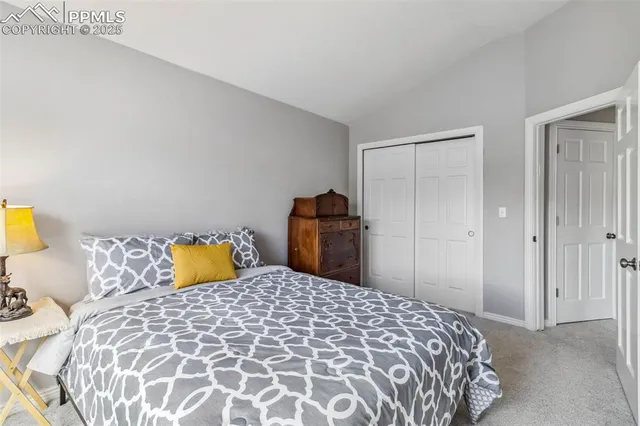 a bedroom with a bed and a lamp