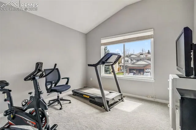 a room with gym equipment and windows
